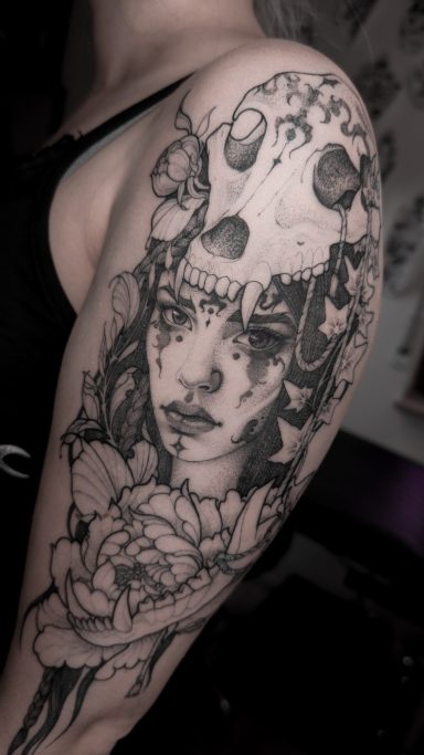 Semi-realistic portrait of a shaman woman with wolf skull and flowers, done in Lörrach by vegan tattoo artist Jannine Stefanov