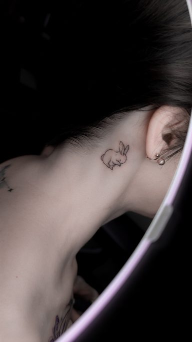 fineline rabbit bunny tattoo behind ear, done in Lörrach by vegan tattoo artist Jannine Stefanov
